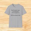 “My therapist says I’m obsessed with vengeance. We’ll see about that.” Funny Therapy Quote Tee